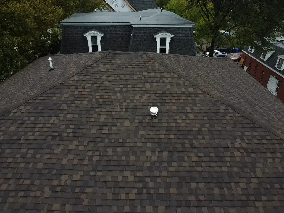 Close aerial view across a finished architectural shingle roof