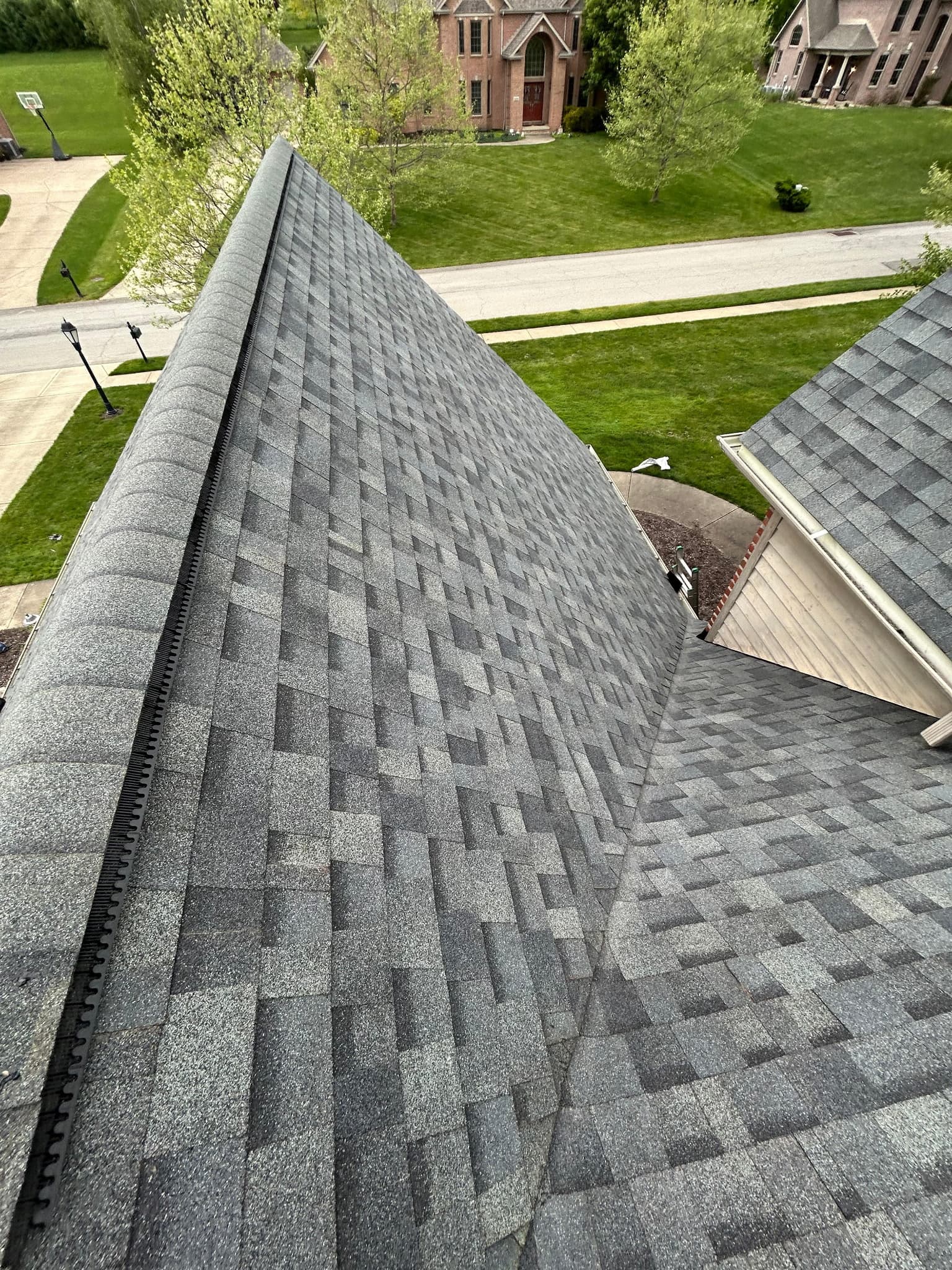 Finished roof ridge with the street and neighborhood in view