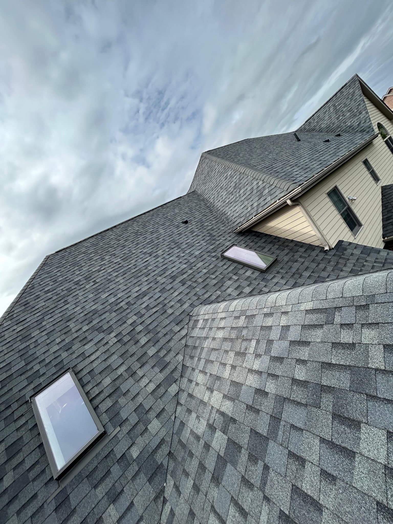Complex roofline with skylight and fresh architectural shingles