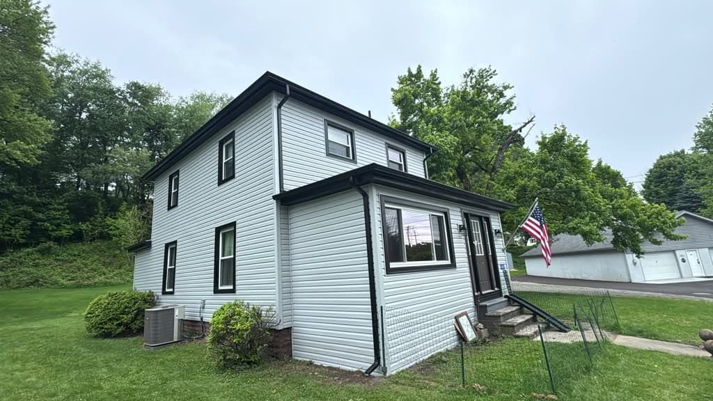 White vinyl siding with bay window detail on the side elevation
